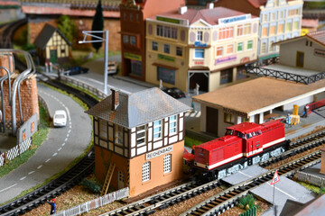 Miniature railway model with trains. Toy Train at Railway Station in a city.
