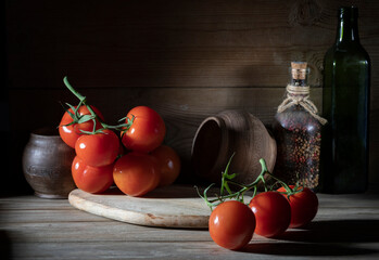 Red tomatoes and ceramic pots on a wooden table