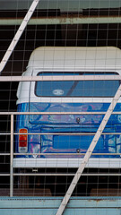 Blue and White Caravan Parked in a Parking Lot