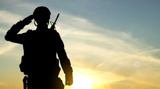 Silhouette of soldier against the sunset. EPS10 vector