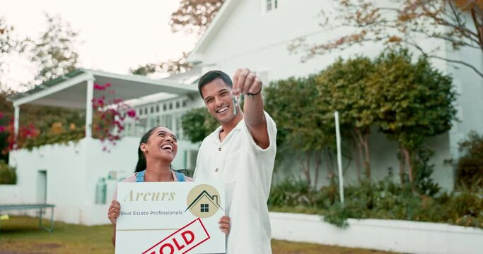 Property, keys and a homeowner couple with a sold sign in the garden of their new house together. Love, mortgage or real estate investment with a married man and woman in the yard for home ownership