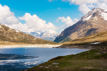 Fototapeta na wymiar Lake in Switzerland in spring with some ice, swiss alps landscape