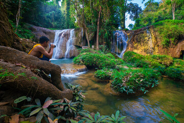 Waterfall in tropical rainforest with green tree forest in Phayao north of Thailand