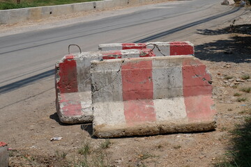 Concrete road blocks are placed to block the road path under construction.
help prevent accidents