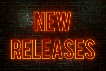 New releases. Brick wall at night, illuminated neon text "New Releases" in orange letters. Upgrade, new ersion, update, business, product, software, process, announcement, marketing.