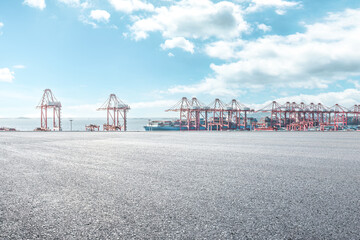 Empty asphalt road and container port background - obrazy, fototapety, plakaty