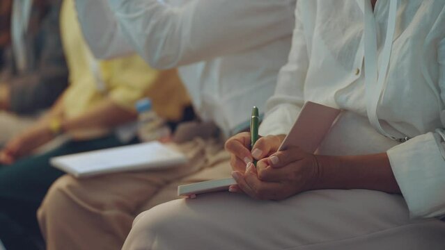 Close-up of writing in a notebook, pen writing in a notebook