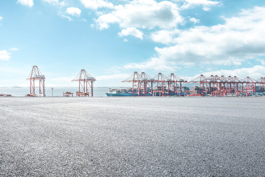 Empty asphalt road and container port background - Powered by Adobe