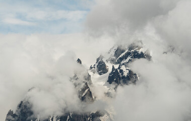 Snowy mountains in clouds