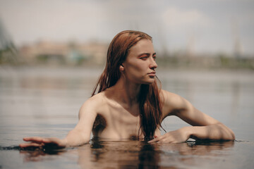 Portrait of naked woman swimming in a lake
