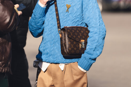 Milan, Italy - January, 13, 2023: man wears monogram pochette metis Louis Vuitton bag, street style details