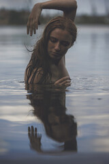 Portrait of naked woman swimming in a lake