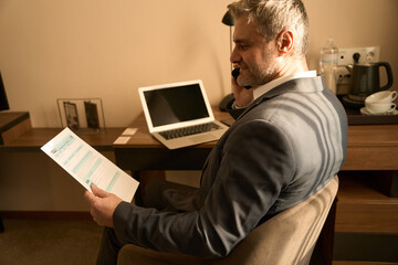 Adult man working with documents in the hotel