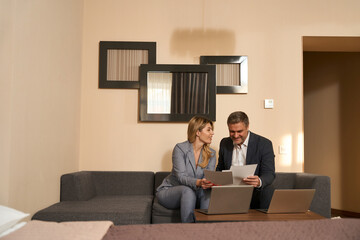 Man and woman working with documents in the motel