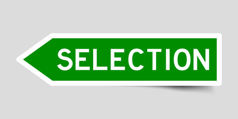 Green color arrow shape sticker label with word selection on gray background