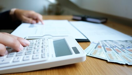 Business woman calculating financial statement on calculator income tax online return and payment