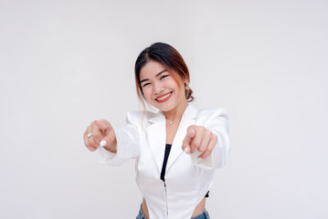 A smiling and cheerful young lady pointing at the camera with both hands. Isolated on a white background.