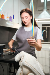 Dry-cleaning operator is treating fur with steam