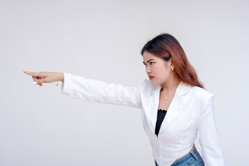 An irked and irritable young woman glaring and pointing to the left. Isolated on a white background. - obrazy, fototapety, plakaty