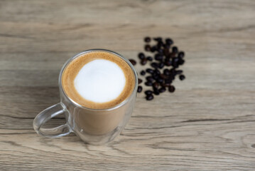 A cup of hot latte on cement table.