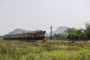 Classic locomotive train on railway in Kanchanaburi, Thailand