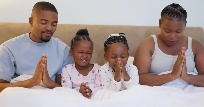Bed, black family or parents praying with children to worship God together in unity with faith or gratitude. Night, mom or African father with girl siblings or kids in a home with hope in religion
