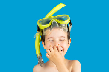 Child with tuba mask and snorkel with hand on his nose smiling and happy.Happiness concept....