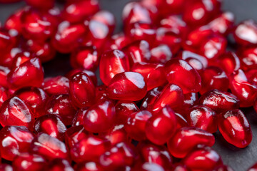 Grains of red ripe pomegranate close up