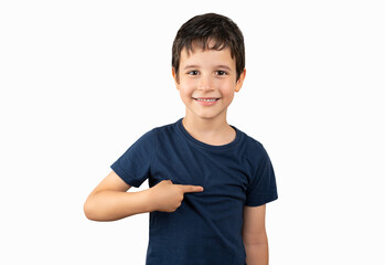 This is me. Portrait of happy preschool boy in blue T-shirt joyfully looking at camera and pointing...