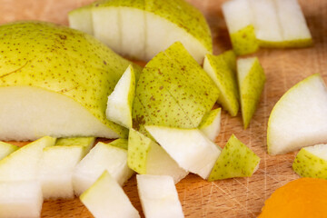 sliced green pear on a wooden board close-up