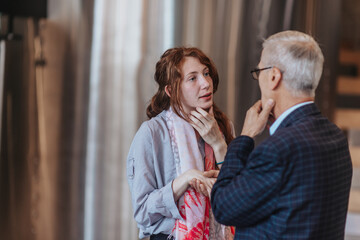 Naklejka premium Different aged business employees shaking hands while having a conversation at the office