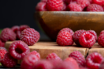 Ripe raspberries on a wooden board