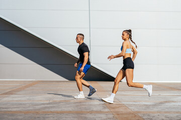 Beautiful sporty couple running outside