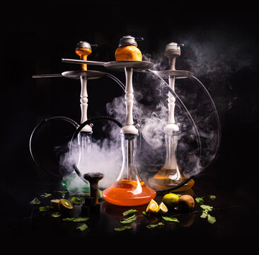 3 Kalyan. Tropical mix. next to it is a leaf and a slice of orange, lemon, mango. with smoke.