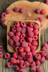 Ripe raspberries on a wooden board