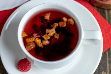 Red raspberry tea with pieces of fruit and berries