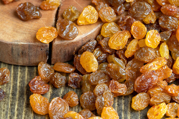 Dried yellow golden raisins on a board
