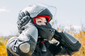 A girl in a motorcycle protective helmet close-up