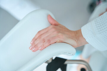 Close up of female hand on gynecological chair