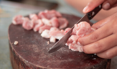 cutting meat on a chopping board