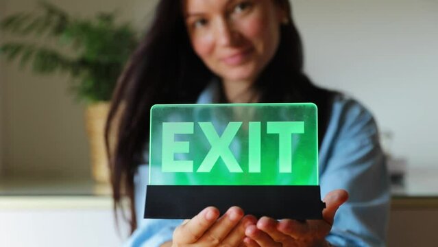 neon word Exit in the hands of a girl, find a way out of a difficult situation, life hack