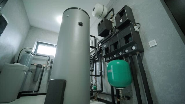 House boiler room interior with modern water heating system