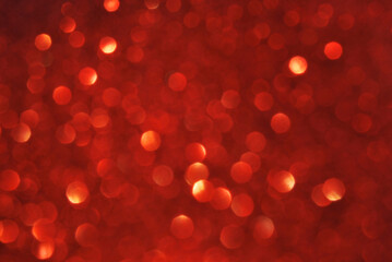 Red de focused sparkle glitter background with golden particles close up
