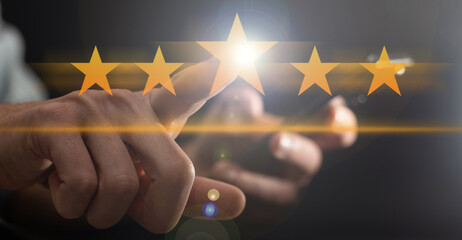 The person's hand pointing at hovering stars. Rating, evaluation.