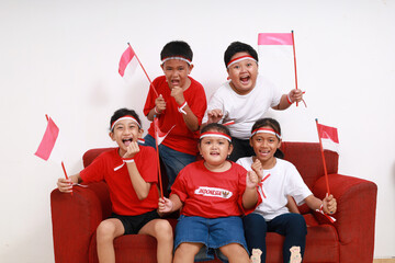 Indonesian kids watching television to supporting Indonesian team