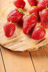 Red strawberry on wooden stand. Fresh ripe delicious strawberries on wooden boards. Copy space