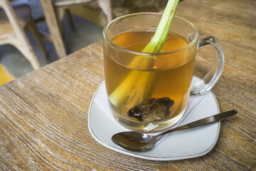 Wedhang Jahe Sere in a glass or Hot Lemongrass Ginger drink is a traditional drink from Java, Indonesia drinks that function as herbal medicines or to overcome body chills. Close-up photo.