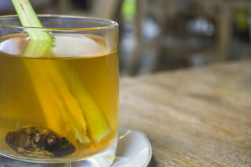Wedhang Jahe Sere in a glass or Hot Lemongrass Ginger drink is a traditional drink from Java, Indonesia drinks that function as herbal medicines or to overcome body chills. Close-up photo.