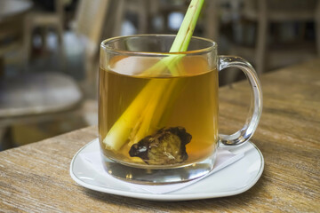 Wedhang Jahe Sere in a glass or Hot Lemongrass Ginger drink is a traditional drink from Java, Indonesia drinks that function as herbal medicines or to overcome body chills. Close-up photo.