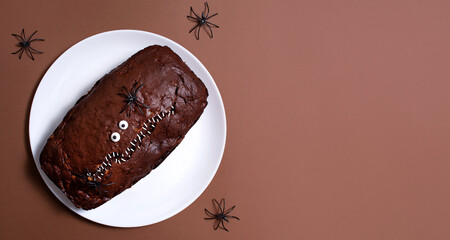 Halloween food. Scary chocolate cake with eyes and spiders on a light background. Terrible food. Thematic food. Halloween background. Copy space. © Юлия Ромашко